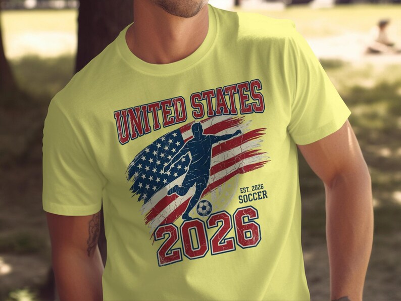 Yellow t-shirt with distressed American flag, soccer player, and "UNITED STATES SOCCER EST. 2026" text.