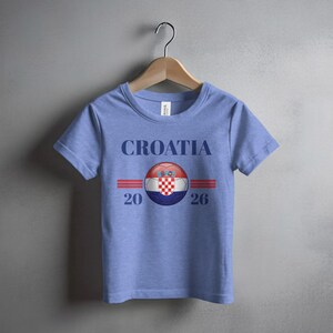 Blue t-shirt with "CROATIA 2026" and a Croatian flag emblem.