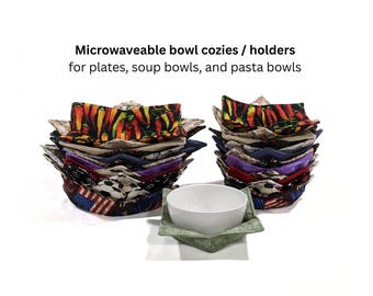 May include: Two stacks of fabric bowl cozies and holders for plates, soup bowls, and pasta bowls, featuring various colorful patterns including chili peppers, soccer balls, and American flags, with one white bowl resting in a green fabric cozy.