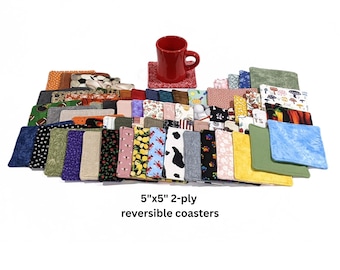 May include: A large collection of square 5"x5" 2-ply reversible coasters featuring a wide variety of colorful patterns and prints, arranged in a cluster with a single red ceramic mug resting on top of one coaster in the center of the display.