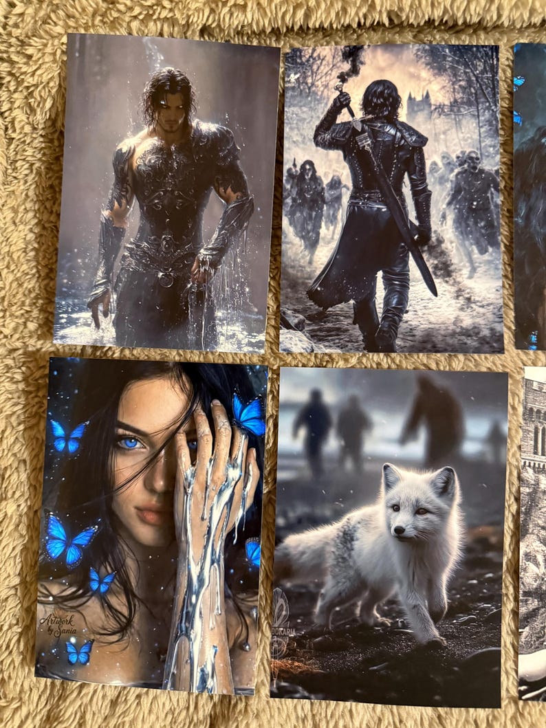 May include: A collection of fantasy art prints. One print features a muscular figure in armor, another depicts a warrior with a torch, a third shows a woman with blue eyes and butterflies, and the last shows a white fox.