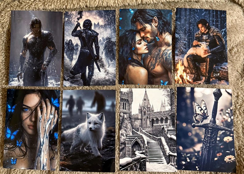May include: A collection of fantasy art prints featuring various scenes. The images depict figures in armor, romantic couples, a white fox, a castle, and a sword with a butterfly. The color palette includes blues, grays, and whites.