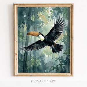 May include: Watercolor painting of a toucan in flight, set against a backdrop of a lush green forest. The bird has black feathers, a white chest, and a large, tan beak. The artwork is framed in a gold-colored wooden frame. The text "FAUNA GALLERY" is at the bottom.