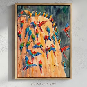 May include: A framed watercolor painting of numerous colorful macaws perched on and around a tan rock formation. The birds display vibrant red, blue, yellow, and green plumage. The artwork is signed "FAUNA GALLERY" at the bottom.