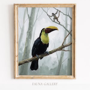 May include: Framed painting of a toucan perched on a branch, with a monkey in the background. The toucan has a yellow beak and chest, black body, and is set against a misty forest backdrop. The frame is a light, natural wood color. The text "FAUNA GALLERY" is at the bottom.