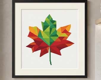 May include: A framed print featuring a geometric maple leaf design. The leaf is composed of red, orange, and green triangular shapes. The artwork is set against a white background and framed in black.