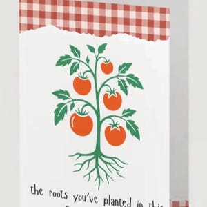 May include: Greeting card with a white background, featuring a green tomato plant with orange tomatoes and the text "the roots you've planted in this family run deep." The top border has a red and white gingham pattern.