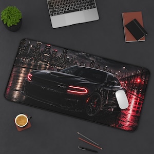 May include: Black rectangular mousepad featuring a black sports car with red lights, set against a city skyline at night. The mousepad has a non-slip surface and is designed for computer use.