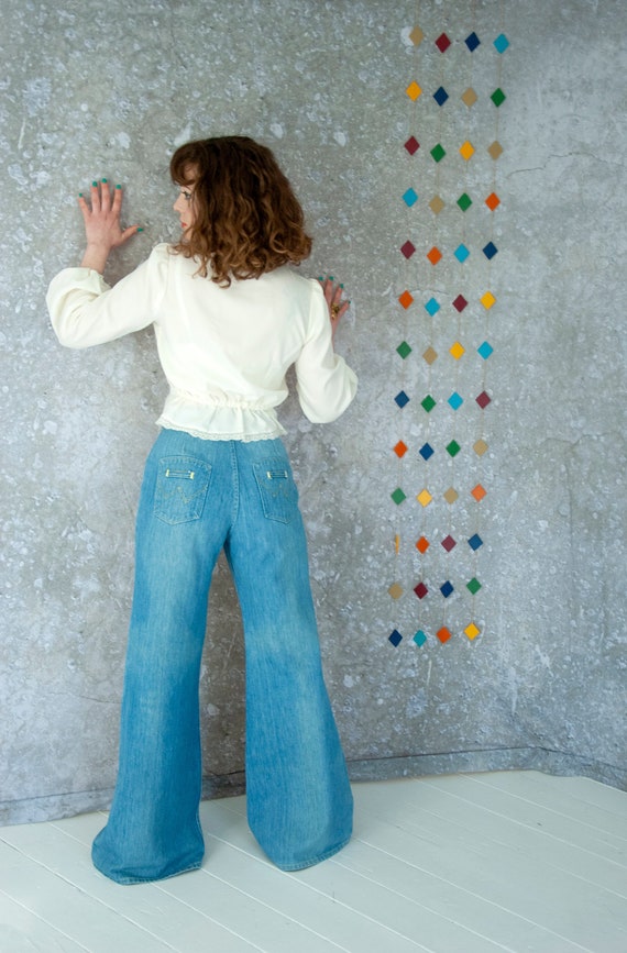 Vintage bell bottom jeans, faded light blue denim
