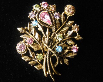 Vintage Brooch in Lightly Antiqued Gold Tone.  2.25"H x 1.75"W Floral Spray Pin. 15 Mixed Pastel Rhinestones are Blooms on Leafy Stems