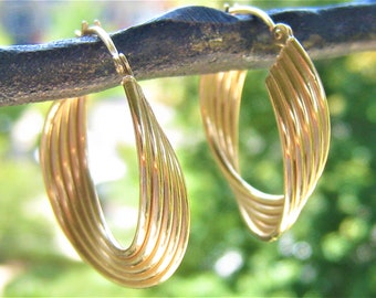 14K Solid Gold Earrings.  5 Hollow Aligned Yellow Gold Tubes Form Each Hoop with 2 Gentle Twists/Turns.  Latch Backs Marked 14K MH or MB
