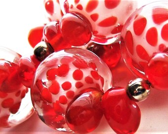 Lampwork Bead Bracelet has 5 big lampwork Red/White/Clear Rondelles, 24 Red Glass Ovals & 6 Silver Spacers.  Artisan made in 1990's