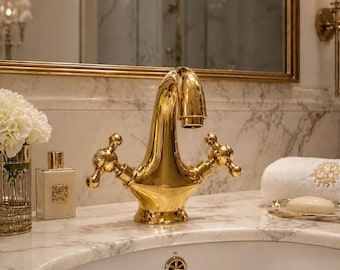 Single-hole bathroom sink faucet in unlacquered brass with simple double cross handles