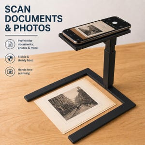 May include: A black document scanner with a smartphone on top, positioned above a vintage photograph. The scanner has a sturdy base and adjustable arm. Text on the image reads "SCAN DOCUMENTS & PHOTOS".