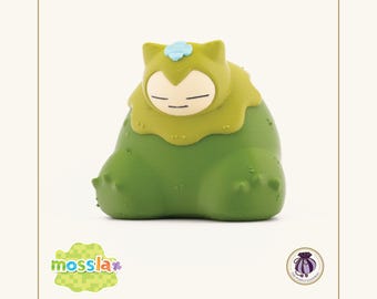 Llavero coleccionable con figura de Mosslax inspirado en Pokopia.