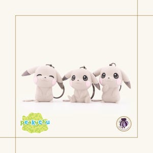 May include: Three light gray Pikachu keychains with black eyes, gray ears, and pink cheeks. Each keychain has a silver-colored keyring. The text "peaky chu" is in the lower left corner.