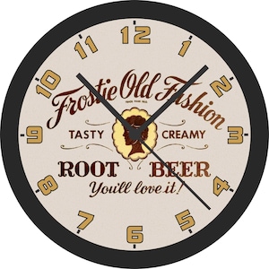 May include: Circular wall clock with a black surround and a cream-coloured face. The clock displays the text "Frostie Old Fashion Root Beer" in a vintage style. The numerals and hands are in a contrasting colour.