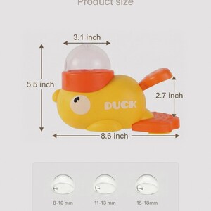 May include: A yellow and orange toy duck with a clear dome on its head. The duck is 8.6 inches long, 5.5 inches tall, and 3.1 inches wide. The wings are 2.7 inches long. The word "DUCK" is printed on the side.