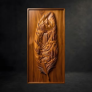 May include: A rectangular wooden wall plaque featuring a detailed relief carving of a feather. The interior of the feather depicts a landscape scene with snow-capped mountains, a cascading waterfall, a flowing river, and evergreen pine trees.