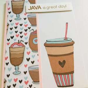 May include: A greeting card featuring a vertical strip of patterned paper with illustrations of coffee drinks and small hearts in black, pink, and blue. A large coffee cup illustration and a white label with the text JAVA a great day! are attached.