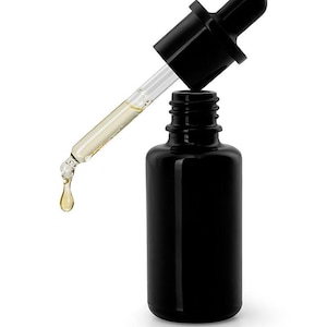 May include: A black glass bottle with a dropper dispensing a golden liquid. The dropper is black with a clear glass tube. A single drop of the liquid is falling from the dropper.