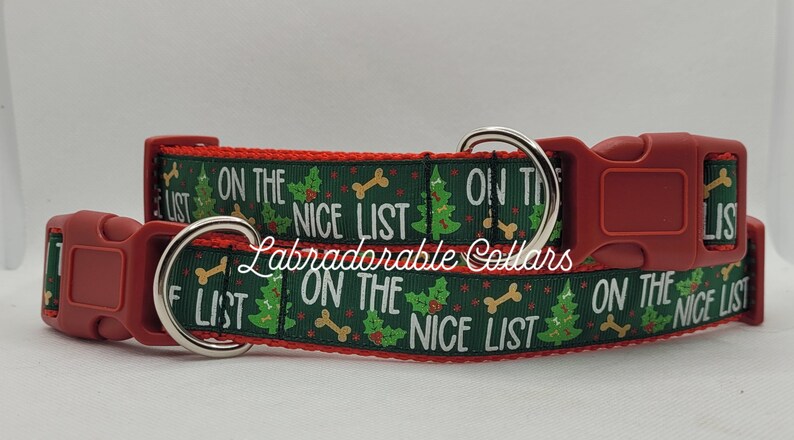 May include: Red and green dog collar with a Christmas tree and bone pattern. The collar has the text "On the Nice List" repeated on it.