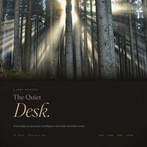 May include: A tranquil forest image with sunbeams piercing through the trees. The words "The Quiet Desk" are featured in stylish lettering, advertising a printable PDF for workspace organisation and improved concentration. The image suggests peace and mindfulness.
