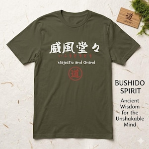 May include: Olive green t-shirt with Japanese characters and the English text "Majestic and Grand." A red circle with a Japanese character is below the text. The shirt also has the text "BUSHIDO SPIRIT" and "Ancient Wisdom for the Unshakable Mind."