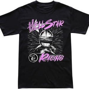 May include: Black t-shirt with a graphic design featuring a racing helmet and the words "HELLSTAR RACING" in pink and white. The design includes a star and a circular emblem.