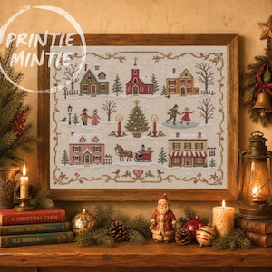May include: A framed cross-stitch embroidery depicting a winter village scene with houses, a church, a central Christmas tree, a horse-drawn sleigh, and figures skating. The design features muted colours on a light fabric, enclosed in a wooden frame.
