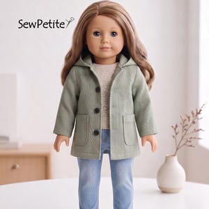May include: A doll with long brown hair wearing a light green hooded jacket with three black buttons and two front pockets, a beige textured sweater, light blue denim jeans, and white sneakers. The text SewPetite is visible in the upper left corner.