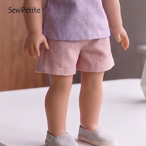 May include: A doll wearing a light purple short-sleeved shirt and pink shorts. The doll is also wearing gray canvas shoes with a woven trim. The text "SewPetite" is visible in the upper left corner.