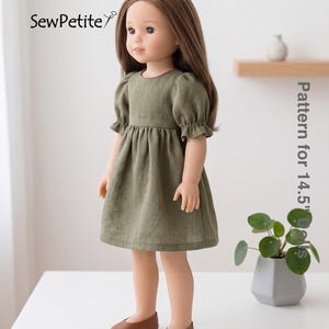May include: A doll wearing an olive green dress with short, ruffled sleeves and brown shoes. The doll has long brown hair and is standing on a white surface. The text "SewPetite" and "Pattern for 14.5" Dolls" are visible.