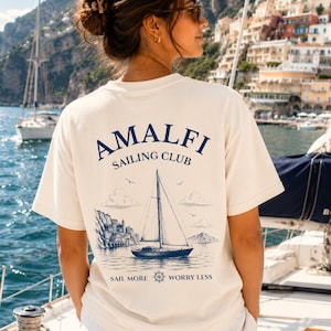 Woman wearing Amalfi Sailing Club shirt with large back design, inspired by Amalfi Coast vacations, sailing trips, and Mediterranean coastal style.