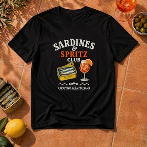 black sardines and spritz club shirt flatlay, bold aperitivo graphic tee, Mediterranean summer party shirt, Italy