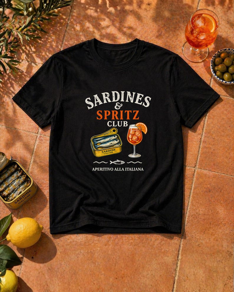 black sardines and spritz club shirt flatlay, bold aperitivo graphic tee, Mediterranean summer party shirt, Italy