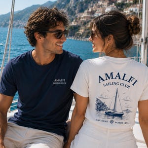 Couple matching shirts with Amalfi sailing club design on a yacht.