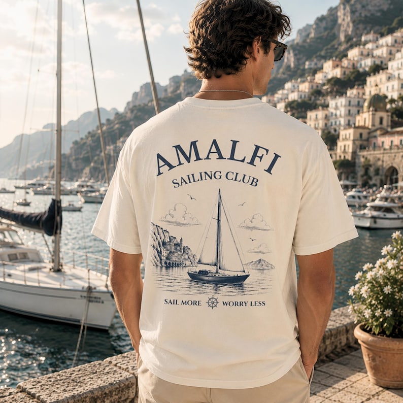 Natural Amalfi Sailing Club shirt with large back print, inspired by Amalfi Coast sailing, yacht club style, and Mediterranean summer vacations.