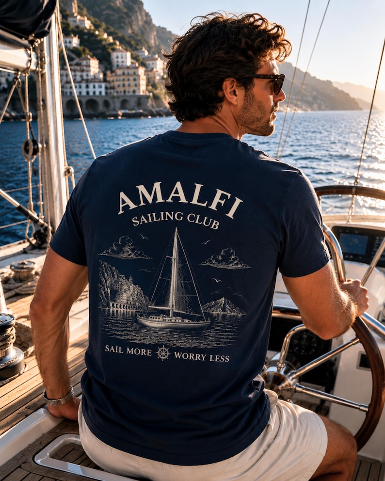 Man wearing Navy Amalfi Sailing Club shirt with large back print on a sailboat, perfect for yacht weekends, sailing trips, and boat lovers.
