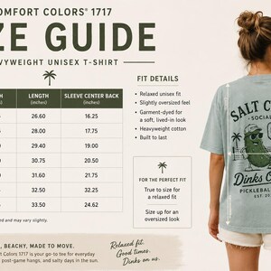 May include: A Comfort Colors 1717 size guide for a heavyweight unisex t-shirt. The chart lists width, length, and sleeve center back measurements in inches for sizes S to 4XL. A light blue t-shirt features a pickleball graphic with the text Salt Club Social Dinks On Us Pickleball Club Est. 2026.