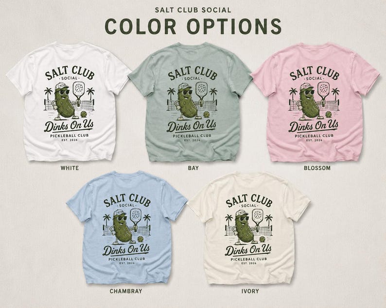 May include: Five short-sleeve t-shirts in white, bay, blossom, chambray, and ivory. Each shirt features a graphic of a pickle wearing sunglasses and a cap, holding a paddle, with the text SALT CLUB SOCIAL Dinks On Us PICKLEBALL CLUB EST. 2024.