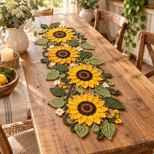 May include: A crochet table runner featuring four large yellow sunflowers with dark brown centers, surrounded by intricate green crocheted leaves and small white flowers, arranged in a continuous vine-like pattern along the center of the table.