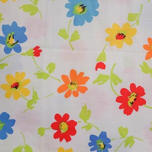 May include: White fabric with a repeating pattern of colorful flowers. The flowers are red, orange, yellow, blue, and green.
