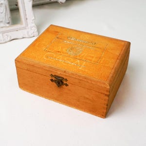 May include: A wooden box with a brass latch. The box is labeled "Caswell" and "Havana, Cuba".