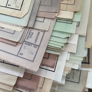 May include: A stack of papers with various sheet numbers, including "Sheet No. 9 of 20" and "Sheet No. E-1/14 of ". The papers are labeled with "Project Title" and "Location".