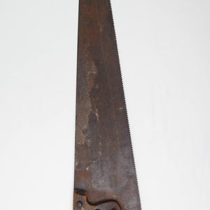 May include: A vintage hand saw with a wooden handle and a rusty metal blade.