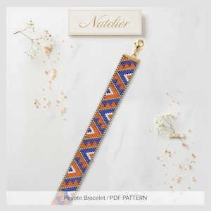 May include: A beaded bracelet featuring a geometric pattern of orange, blue, and white triangles. The bracelet has a gold-tone metal clasp and is displayed near a rectangular card with the text Nateliér and the text Peyote Bracelet / PDF PATTERN.