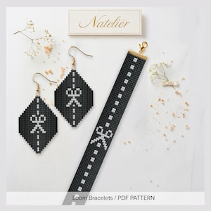 May include: A pair of diamond-shaped beaded earrings and a matching long beaded bracelet, both featuring a black background with a white pixelated scissor icon and a dashed line pattern. The jewelry includes gold-toned metal hooks and a clasp.