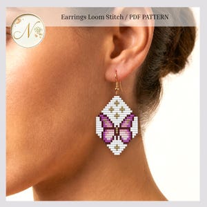 May include: A diamond-shaped earring featuring a loom stitch bead pattern of a butterfly in shades of purple, white, and gold. The design includes the text Earrings Loom Stitch / PDF PATTERN at the top. The earring hangs from a gold-toned hook.