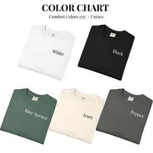 May include: Color chart featuring five Comfort Colors 1717 unisex t-shirts in various colors: white, black, blue spruce, ivory, and pepper. The text "COLOR CHART" and "Comfort Colors 1717 - Unisex" are at the top of the image.